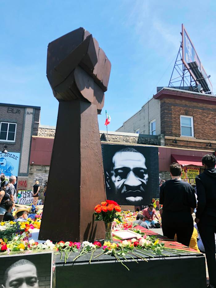 A fist statue at a memorial for George Floyd